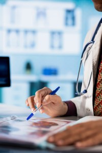 general-practitioner-consulting-patient-reviewing-x-ray-test-results